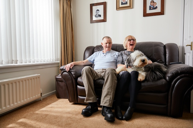 Couple with dog on a couch